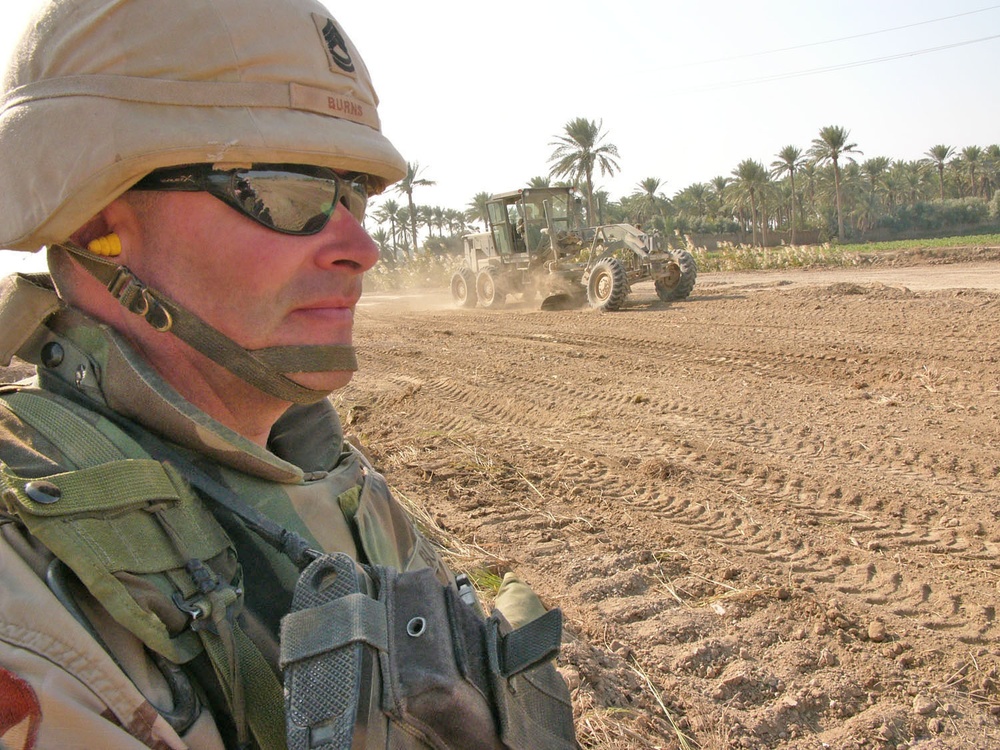 Sgt.1st Class Duane Burns looks on as one of his Soldiers levels