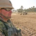 Sgt.1st Class Duane Burns looks on as one of his Soldiers levels