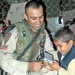 Pfc. Oscar Buonafina allows a child to play with his Gameboy