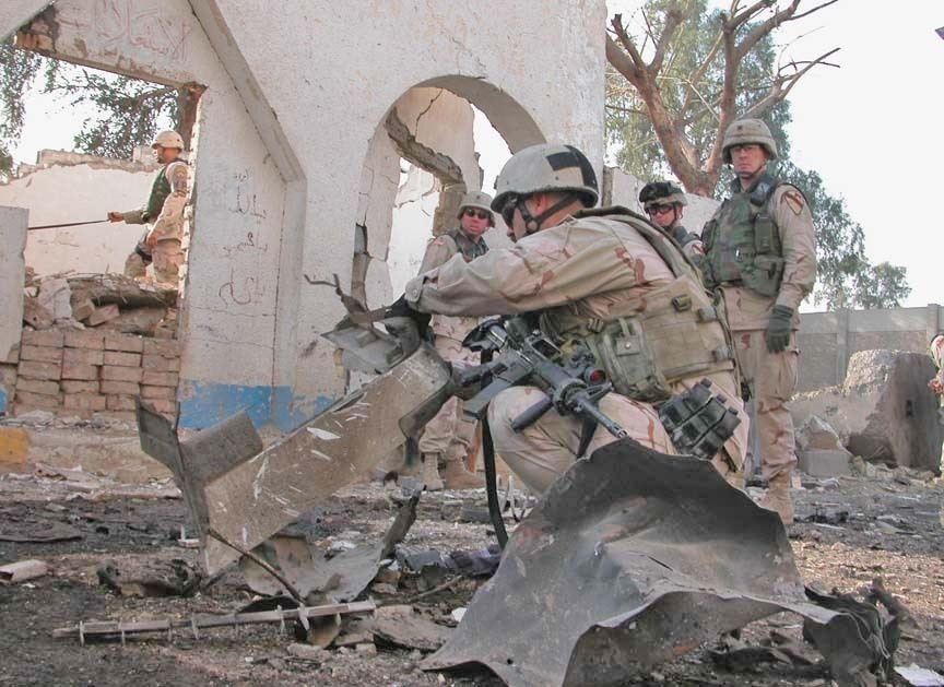 Explosive ordnance personnel sift through the wreckage