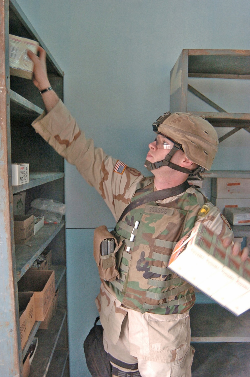 Sgt. Scaggs puts donated medical supplies onto a shelf