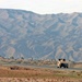 A HMMWV drives toward a small village near the Tigris River