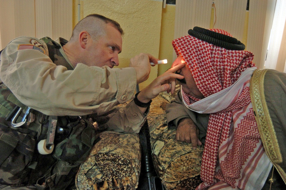 Capt. Sherman performs a courtesy examination of a sheik's eye