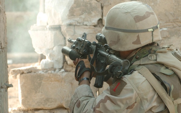 PFC David L. Gilette returns fire on insurgents