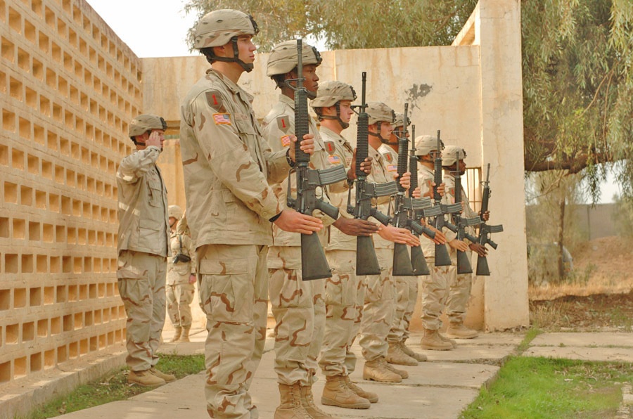 A firing squad salutes SPC Erik W. Hayes