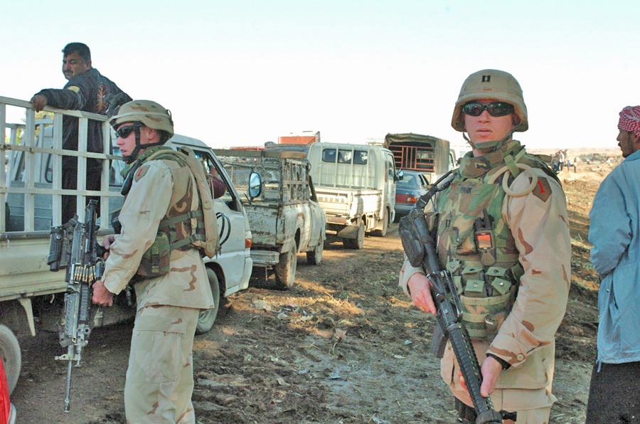 Soldiers lead their convoy through stopped traffic