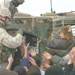 Soldiers hand out candy and school supplies to village children