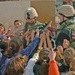 Soldiers hand out backpacks to Iraqi schoolchildren