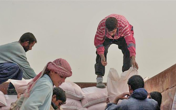 Council members distribute grain seed to local farmers
