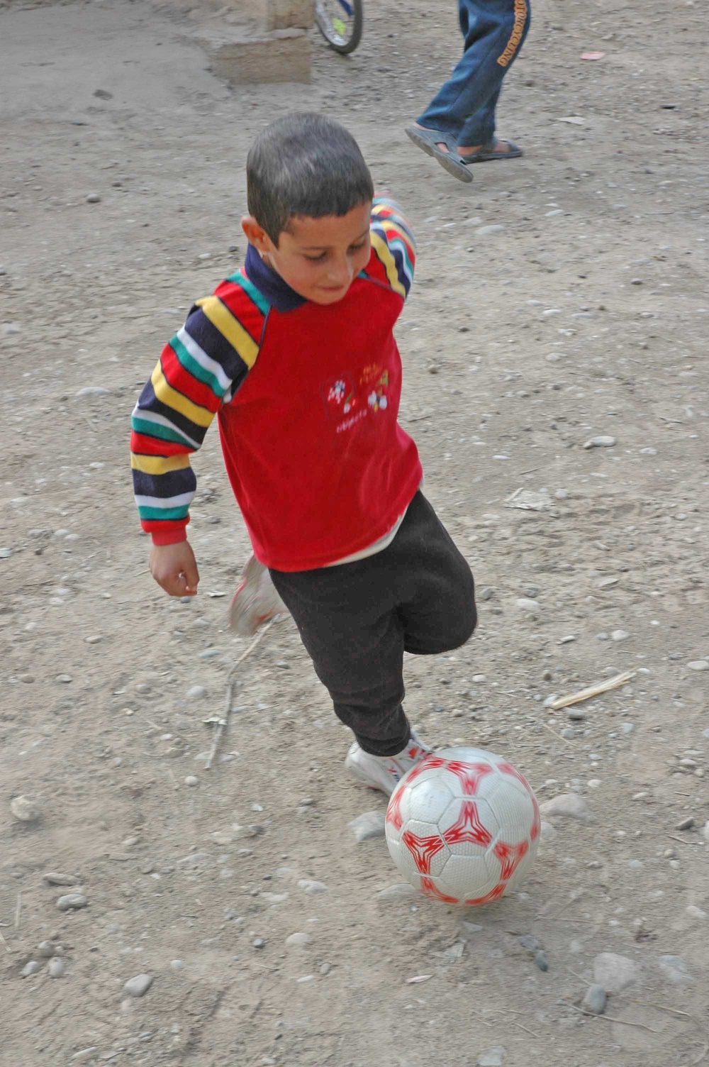 Another child happily puts a new toy to use