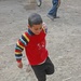 Another child happily puts a new toy to use