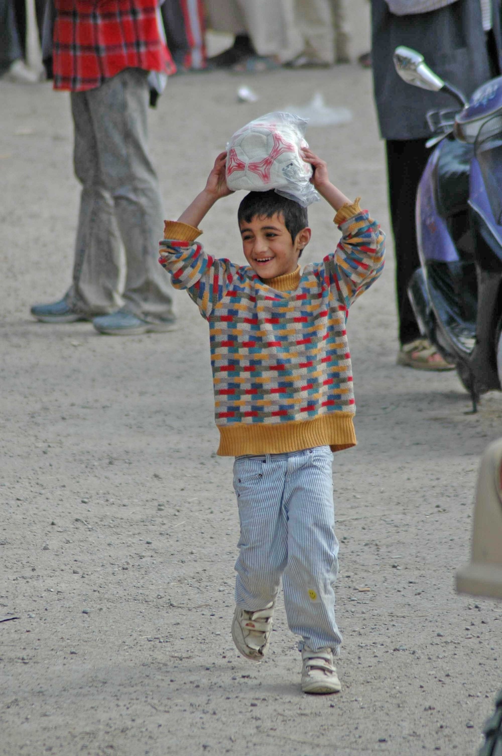 A smile stretches across the face of an Iraqi child