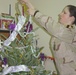 Pfc Erika Bruner places the tradition topper on a real, Christma