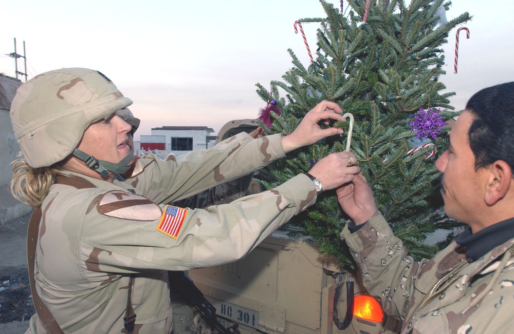 Sgt. Maj. St. Louis shows members how to decorate a Xmas tree
