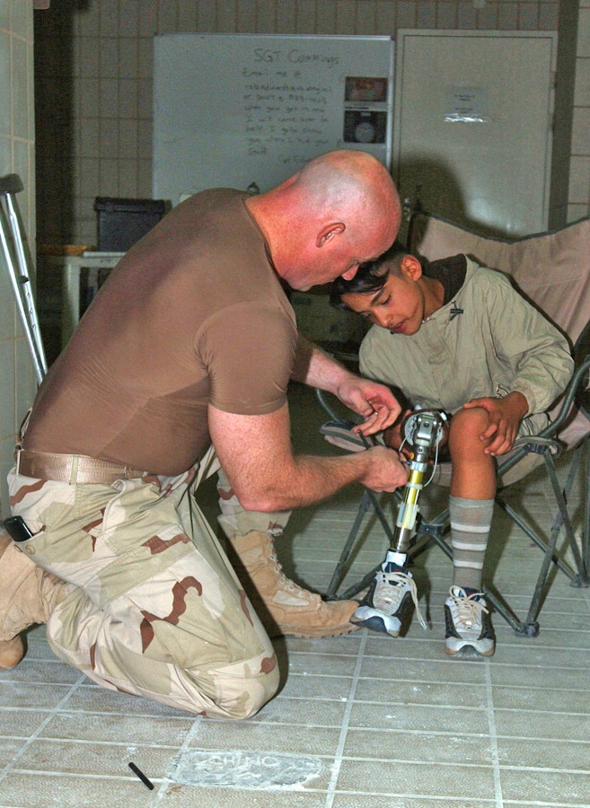 Capt. Steve Lindsley makes adjustments to the prosthetic leg