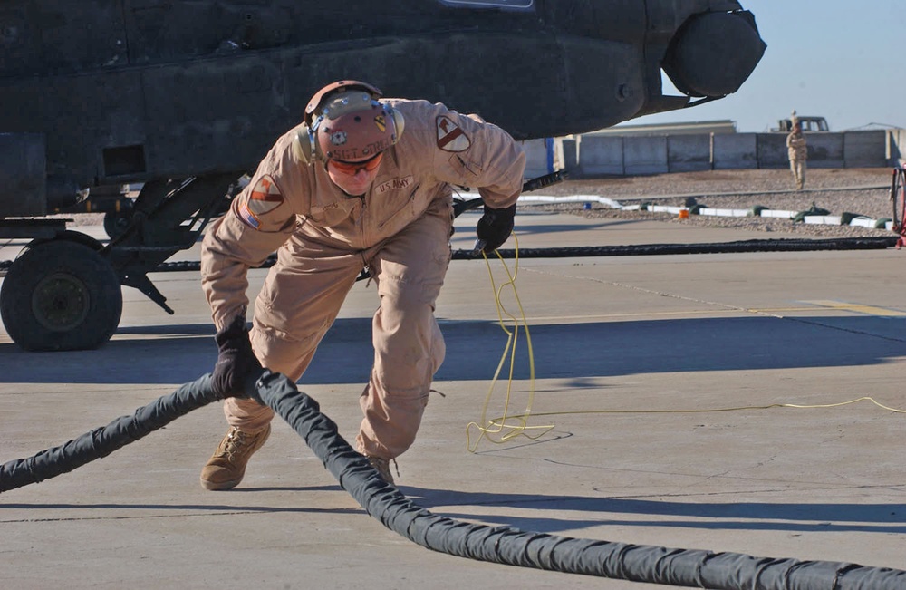 Sgt. Rob Trigg pulls a hose off the landing pad