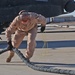 Sgt. Rob Trigg pulls a hose off the landing pad