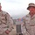 Two soldiers relax outside their tent city at Camp Striker