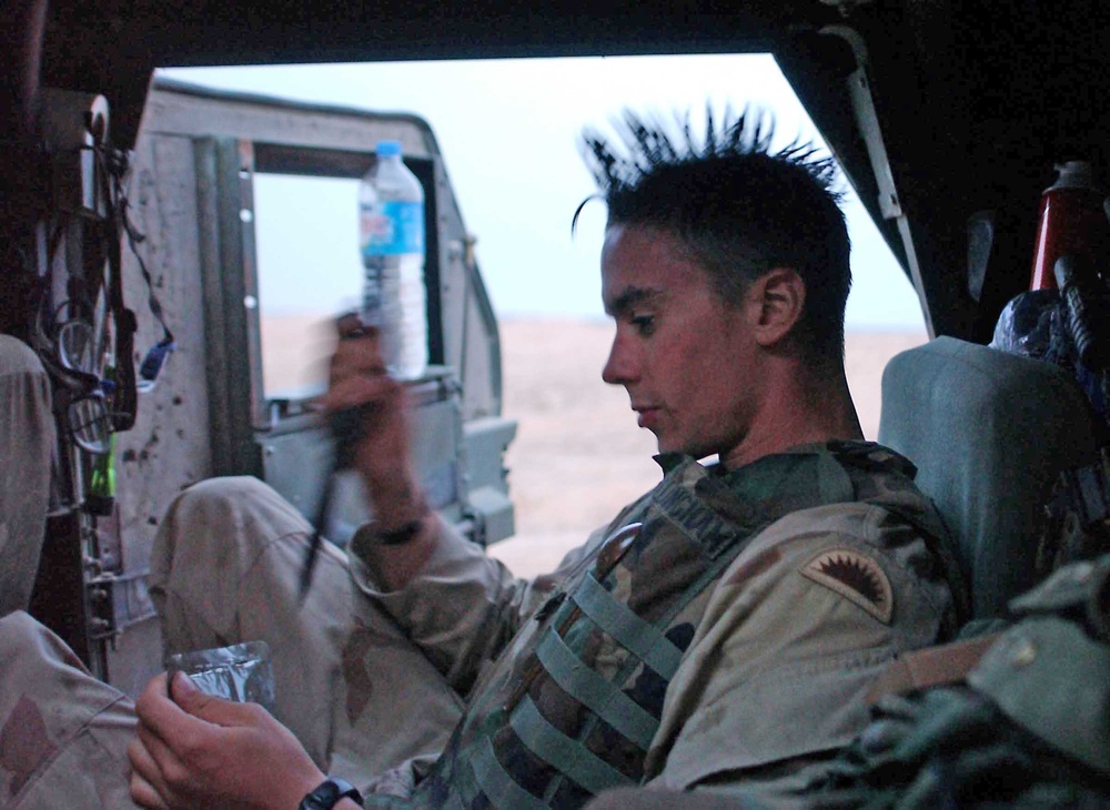 Spc. John Willingham  prepares to open a Meal Ready to Eat