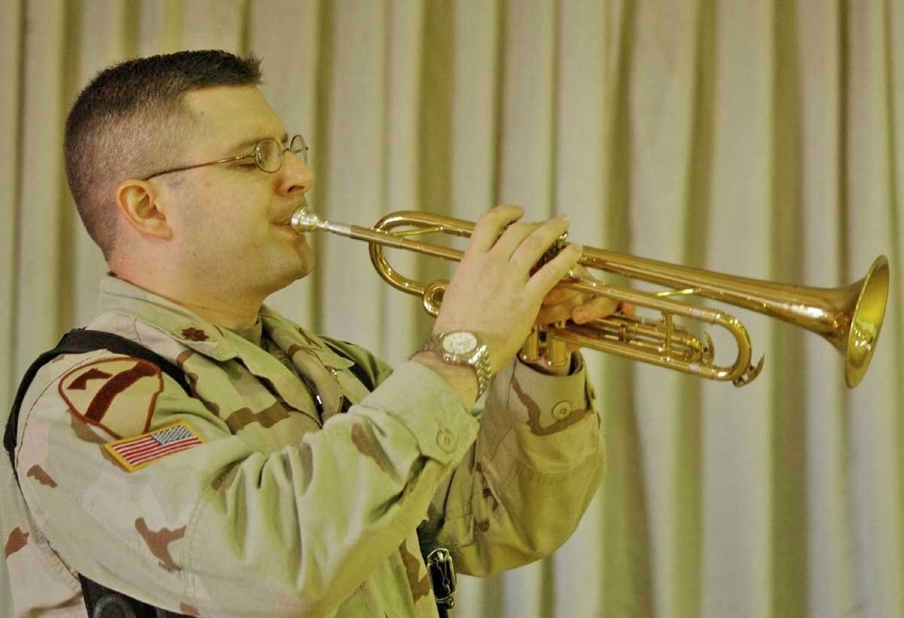 Maj. Mike Spraggins plays Taps as a final farewell