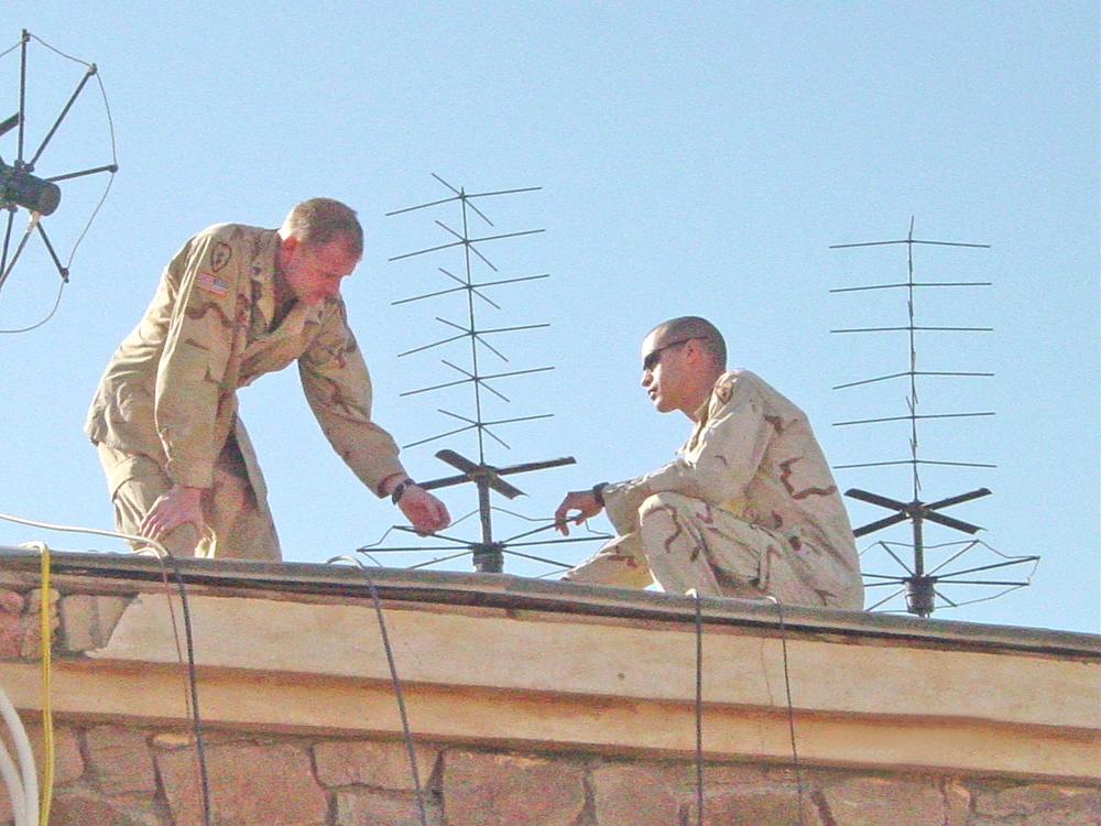 Soldiers set up a tactical satellite antenna