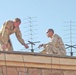 Soldiers set up a tactical satellite antenna