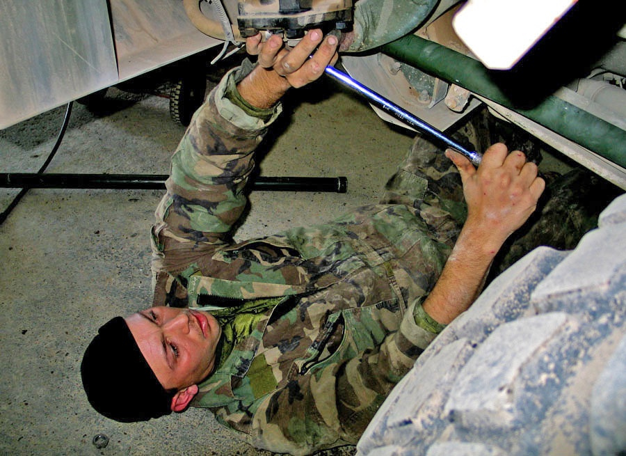 SPC Vernan Roberts changes a drag link on a vehicle