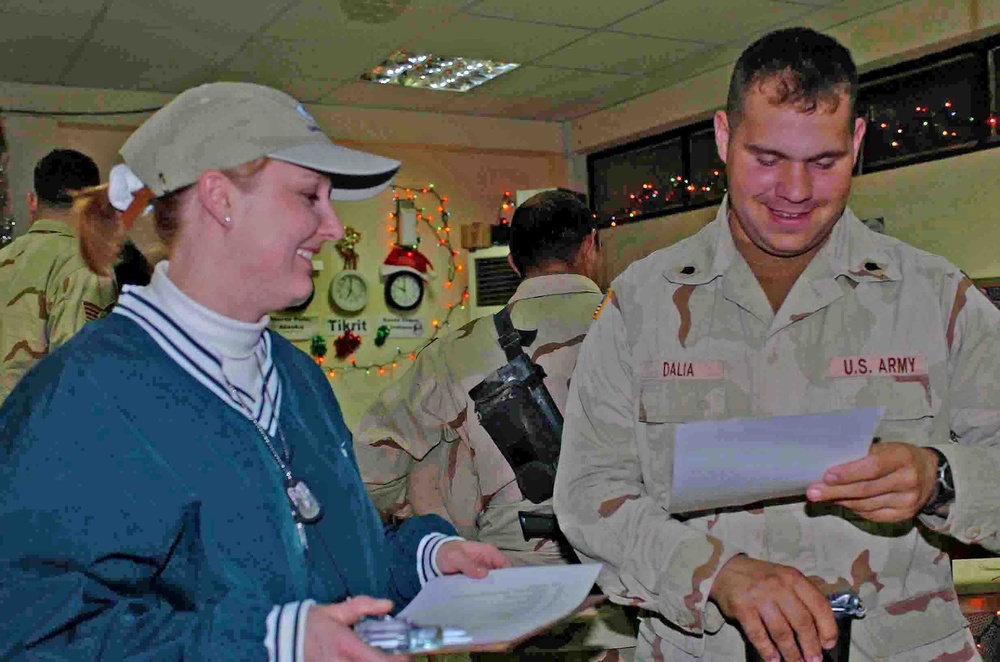 Spc. Brandon J. Dalia looks over a holiday scavenger hunt list