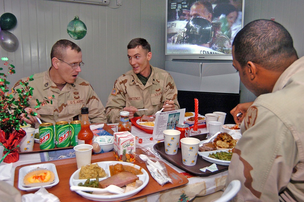 Soldiers share a conversation during their Christmas meal
