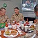 Soldiers share a conversation during their Christmas meal