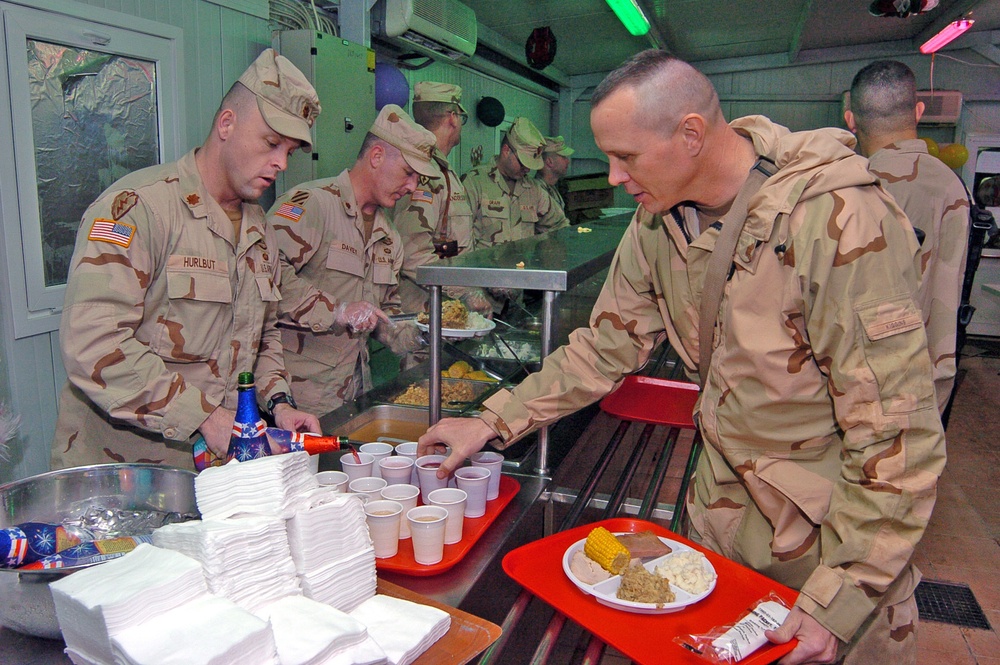 Maj. Dan Hurlbut pours glasses of sparkling grape juice for Sold