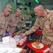 Maj. Dan Hurlbut pours glasses of sparkling grape juice for Sold