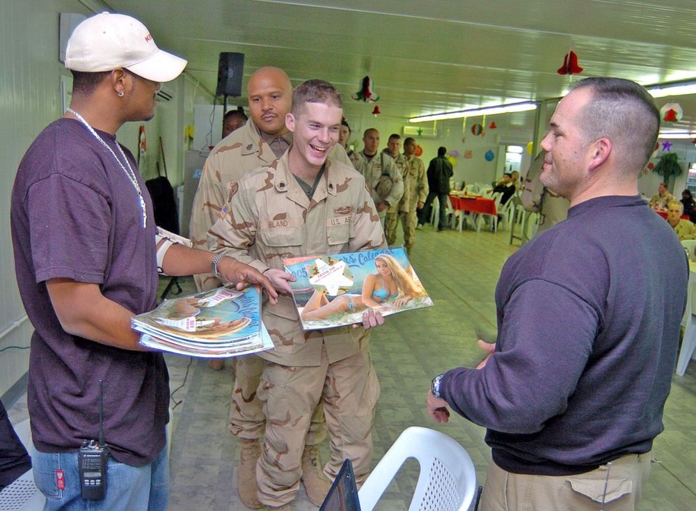 Army Spc. David Bland smiles as he receives a free 2005 Hooters