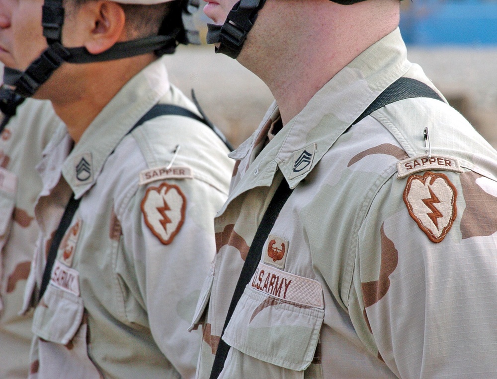 Soldiers stand in formation with their new Sapper tabs