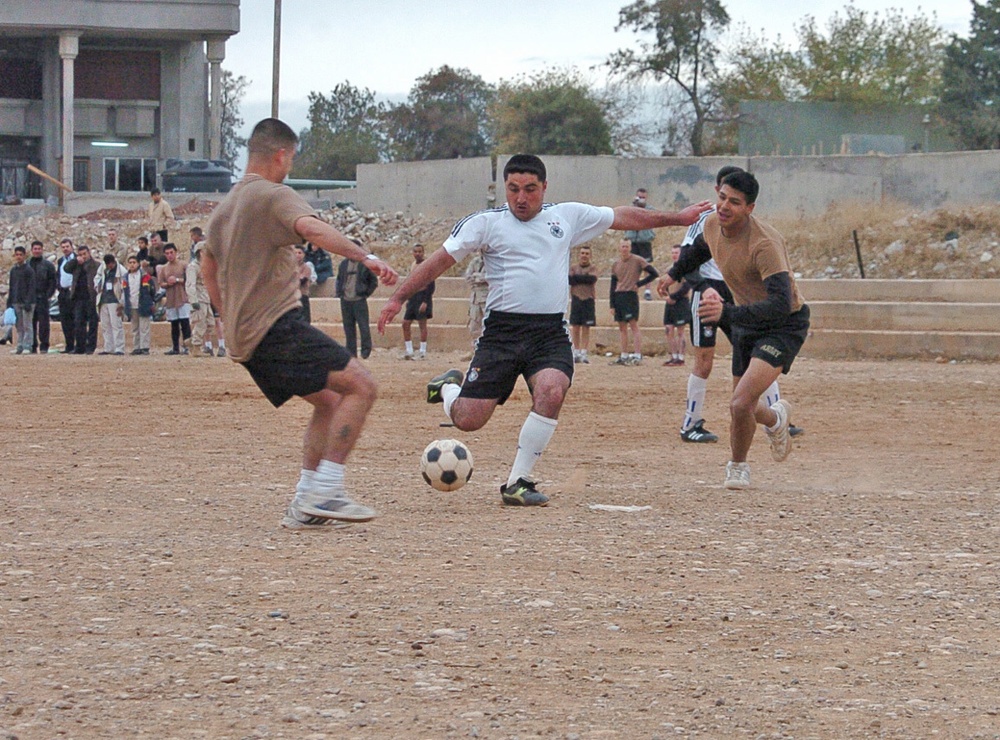 Mariwan Noory prepares to kick a soccer ball past Bravo Co. defe