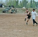 Elliot Scott kicks a soccer ball toward the Iraqi Police goal