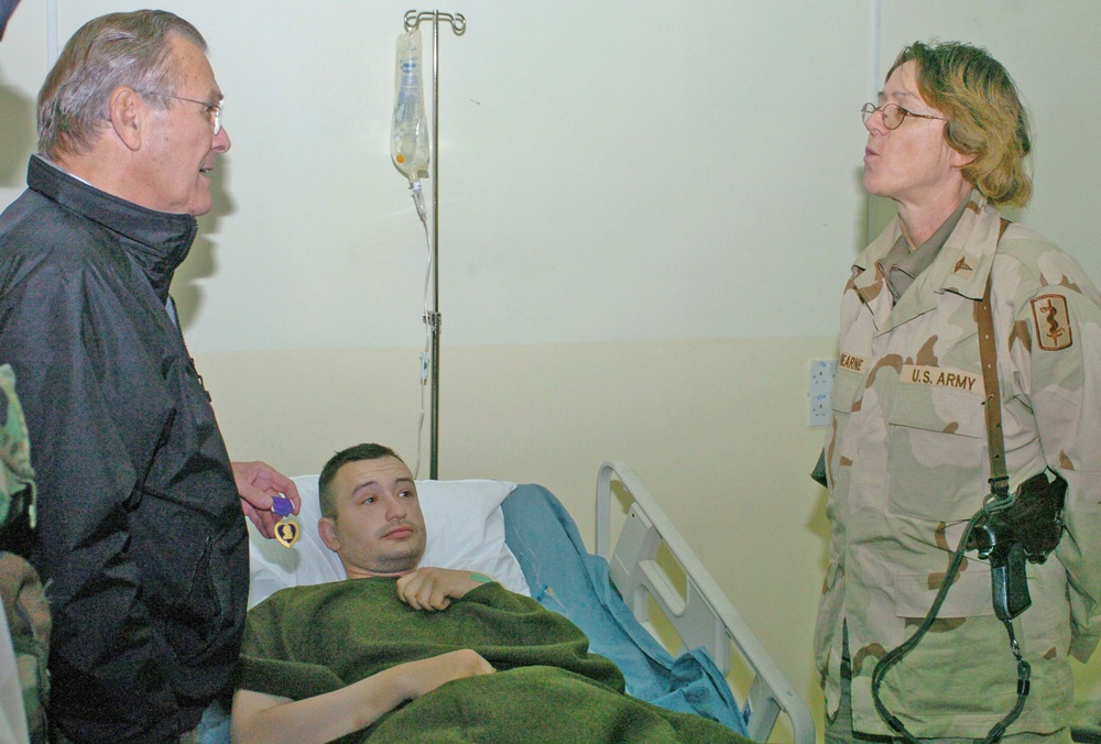Secretary Rumsfeld awards purple heart to Soldier injured in Mos