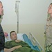Secretary Rumsfeld awards purple heart to Soldier injured in Mos