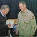 Secretary Rumsfeld signs book for Soldier in Iraq
