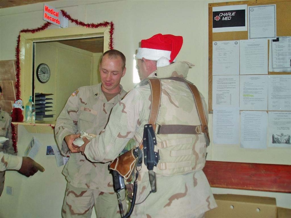 1st Sgt. Harvey presents one of his Soldiers with a meal