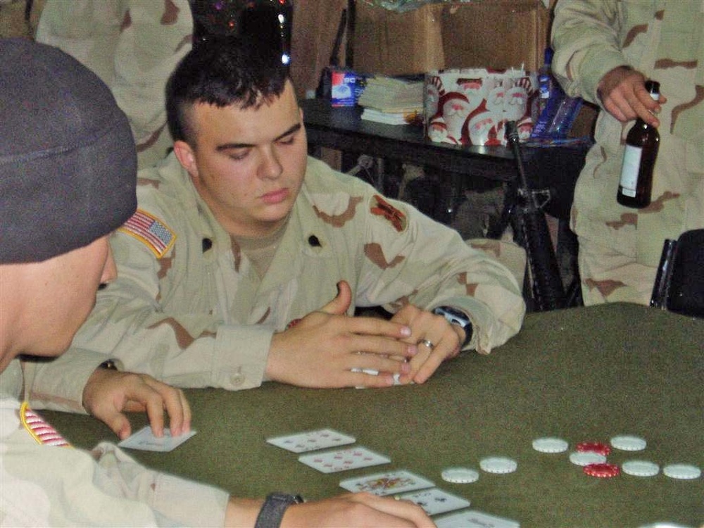 Spc. Andrew Malaxonis participates in a card game