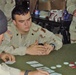 Spc. Andrew Malaxonis participates in a card game