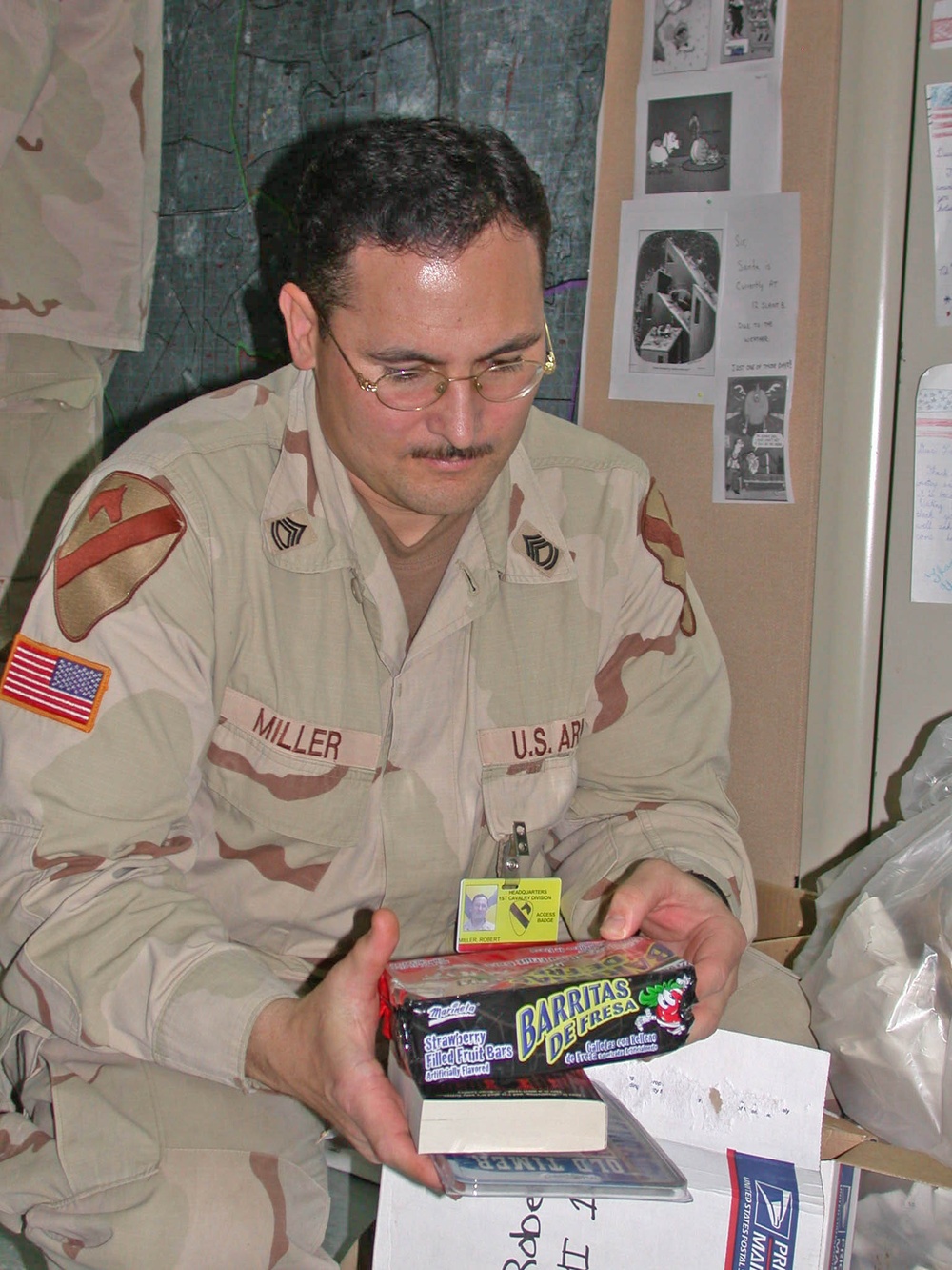 Sgt. 1st Class Robert Miller opens a present