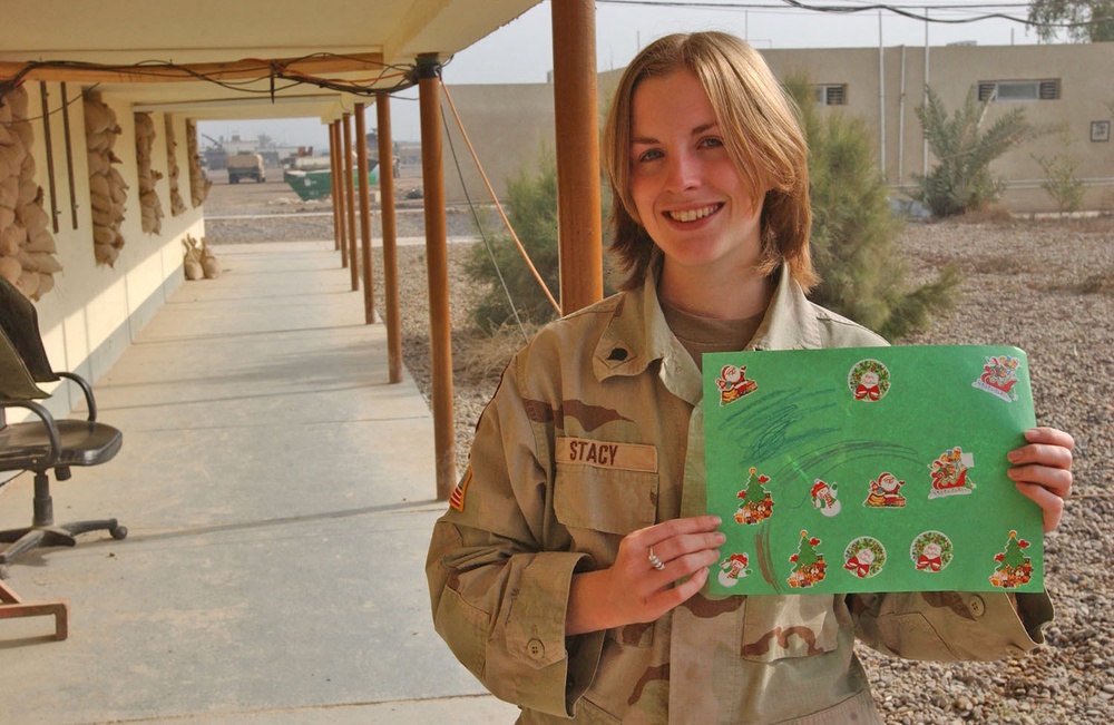Spc. Jessica Stacy displays one of the hundreds of Christmas car