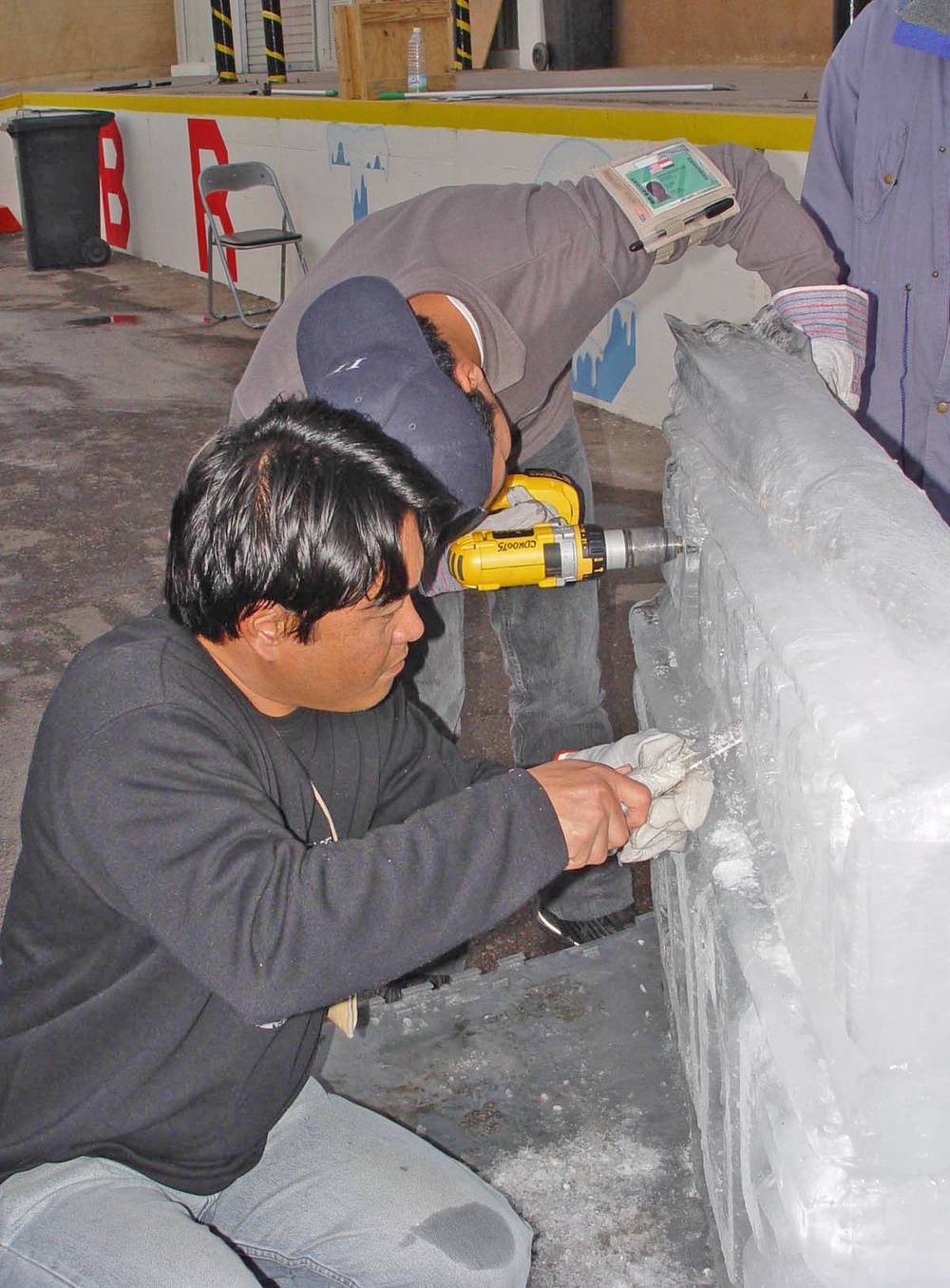 Two ice plant workers put finishing touches