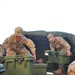 Pfc. Patrick Fenton helps unload empty food containers