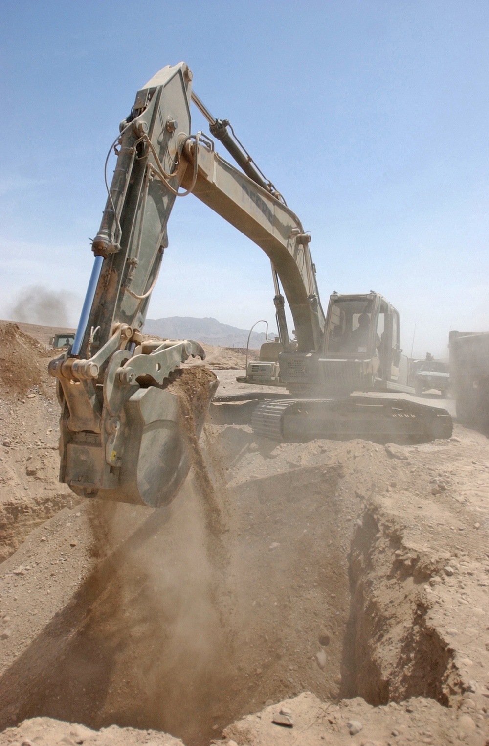 Sgt. Wilson Harding uses an excavator to collect dirt