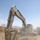 Sgt. Wilson Harding uses an excavator to collect dirt