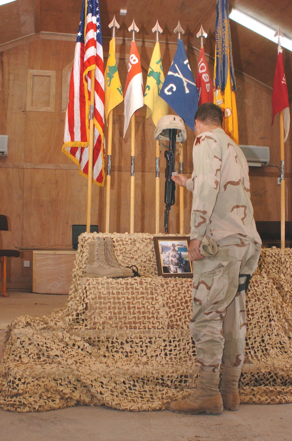 A Soldier reads the dog tags of 1st Lt. Barnett