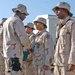 Spc. Moses Diaz shakes hands with Col. John L. Smith